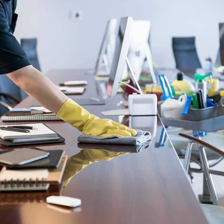 white Cleaning a laptop screen at an office desk