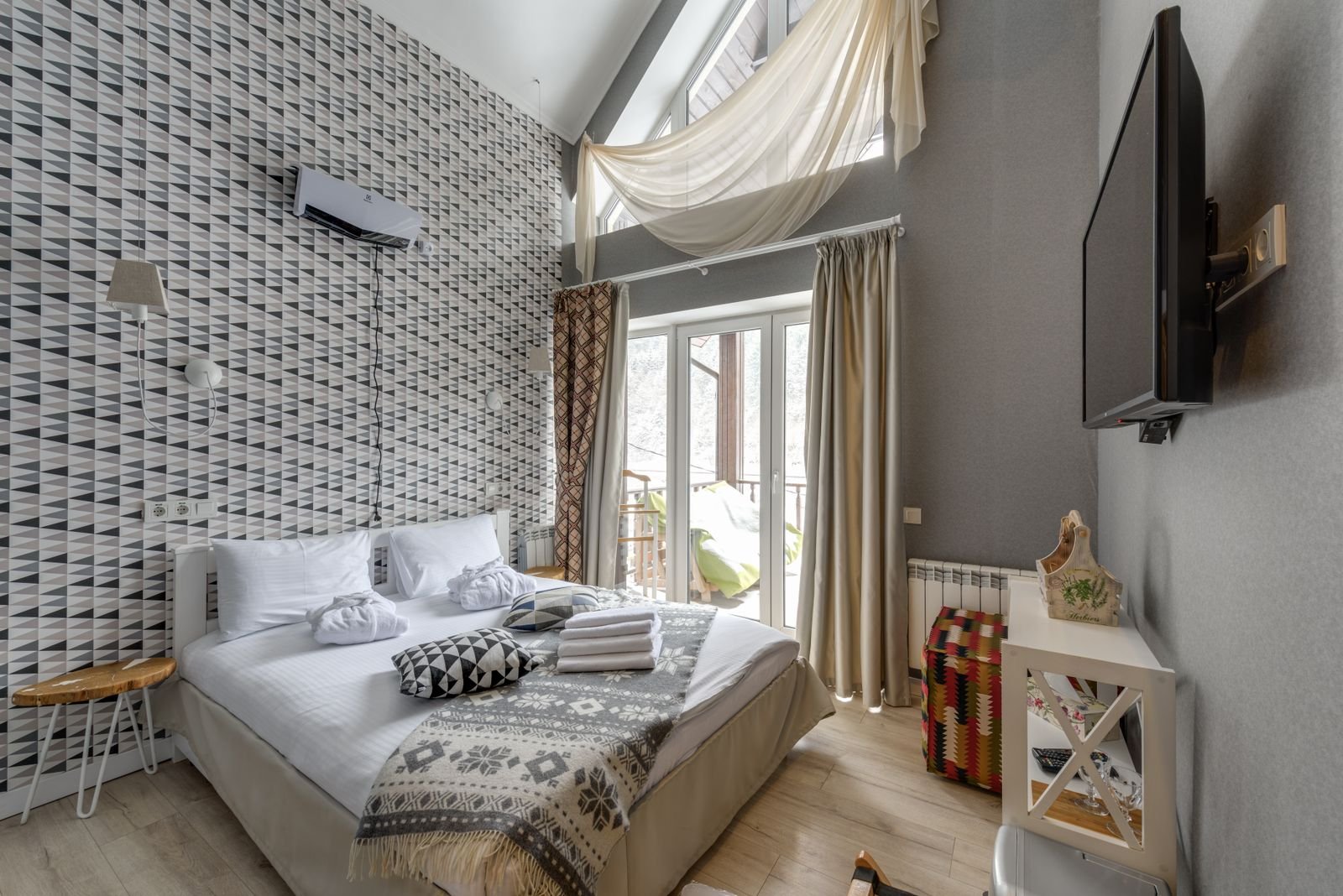 Bright, modern short-term rental bedroom with large windows